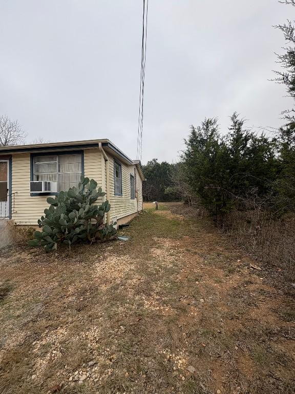 view of side of home featuring cooling unit