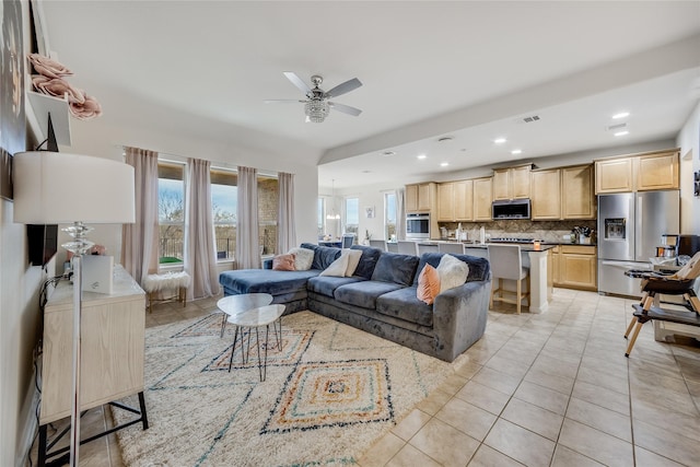 tiled living room featuring ceiling fan