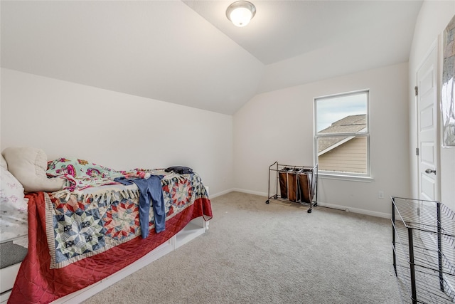 carpeted bedroom featuring lofted ceiling