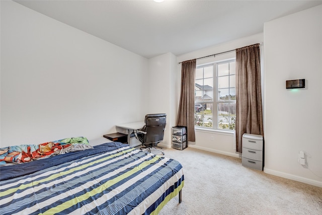 bedroom with multiple windows and light carpet