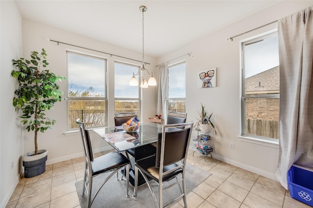 tiled dining room with an inviting chandelier