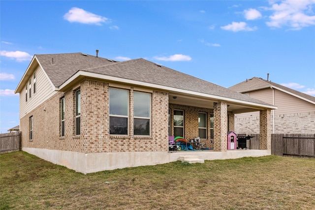 back of property featuring a lawn