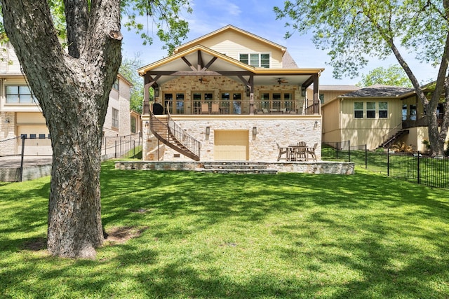 rear view of property featuring ceiling fan, a yard, a balcony, a garage, and a patio area