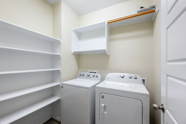 clothes washing area with washing machine and dryer