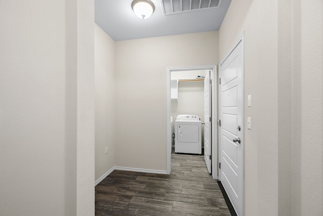 clothes washing area with washer and dryer and dark hardwood / wood-style floors