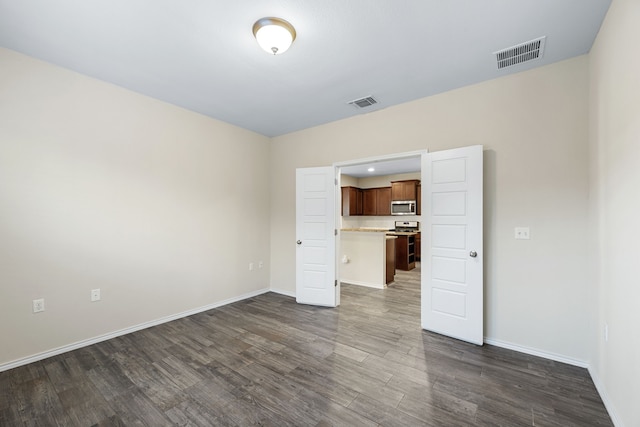 unfurnished living room featuring dark hardwood / wood-style floors