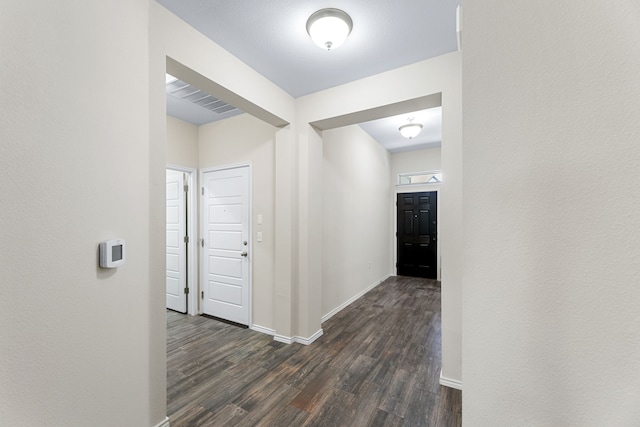 hallway featuring dark wood-type flooring