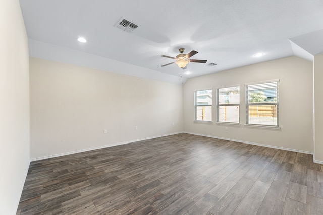 spare room with dark hardwood / wood-style floors, ceiling fan, and lofted ceiling