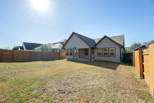 back of property featuring a lawn and a patio area