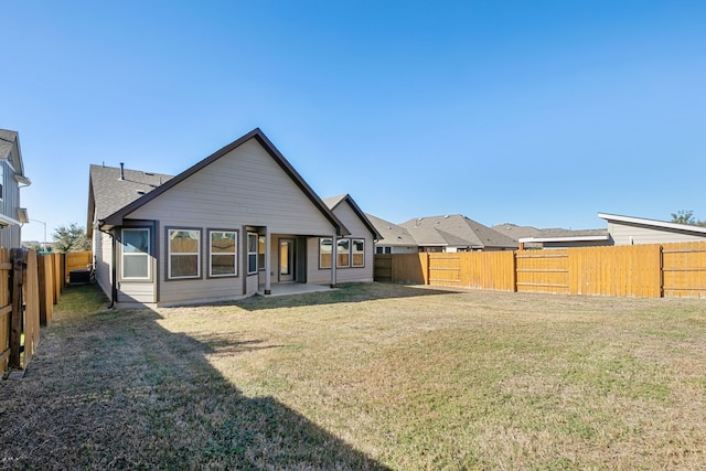 rear view of property featuring a yard