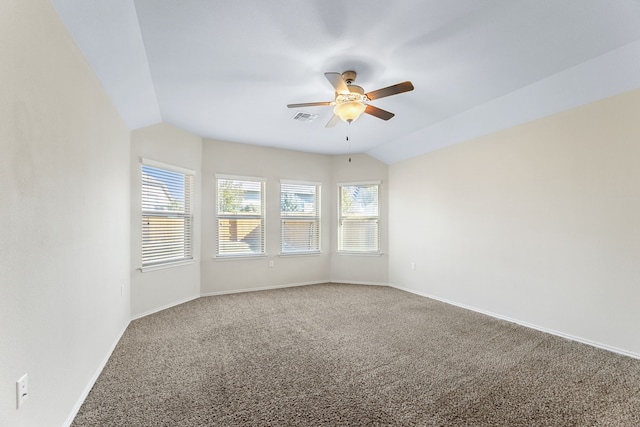 carpeted spare room featuring ceiling fan and vaulted ceiling