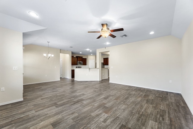 unfurnished living room with lofted ceiling, ceiling fan with notable chandelier, and dark wood-type flooring