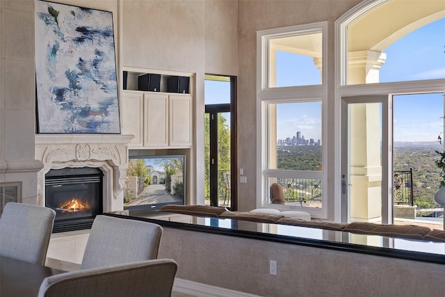 living area featuring a wealth of natural light and a premium fireplace