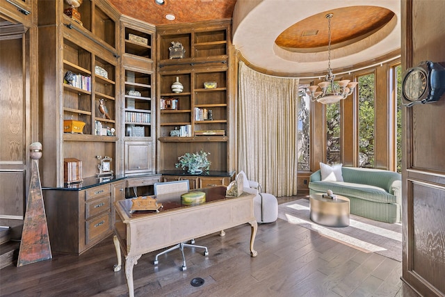 office with a chandelier, dark hardwood / wood-style flooring, built in features, and a tray ceiling