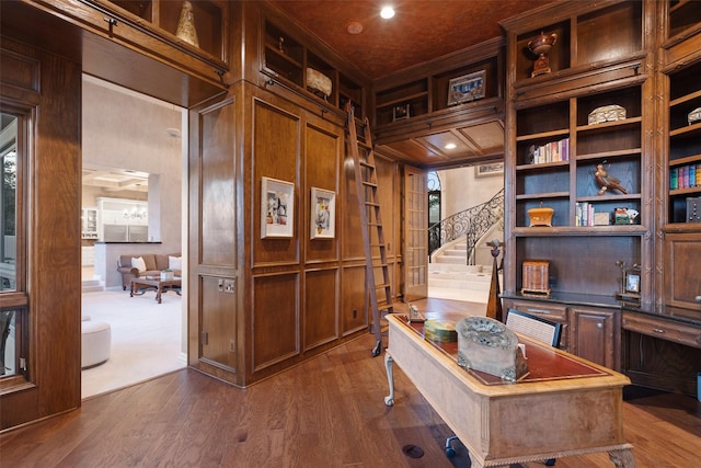 office space featuring dark hardwood / wood-style flooring and wooden walls