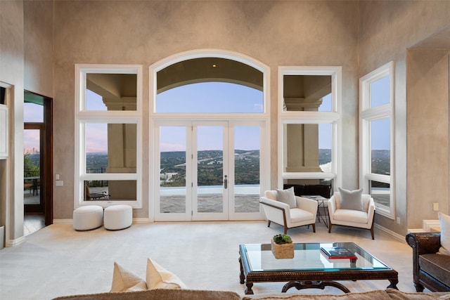 sunroom / solarium featuring a mountain view and french doors