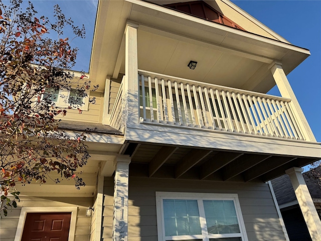 view of side of home featuring a balcony