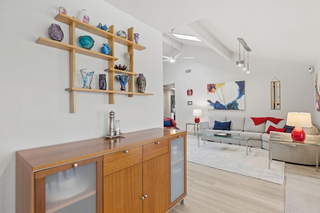 kitchen with visible vents, lofted ceiling with beams, open floor plan, light wood-style floors, and open shelves