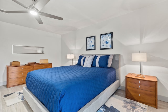 bedroom featuring a ceiling fan, light wood-type flooring, and baseboards