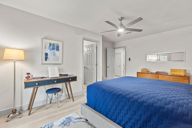 bedroom featuring baseboards, visible vents, ceiling fan, and wood finished floors