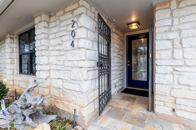 property entrance featuring stone siding