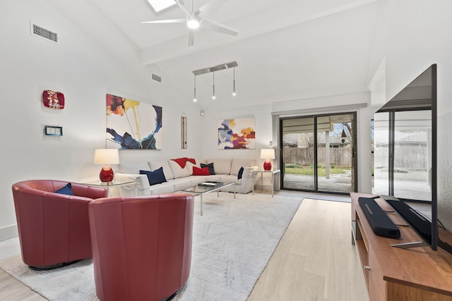 living room with ceiling fan, light hardwood / wood-style flooring, beamed ceiling, and high vaulted ceiling