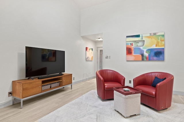 living area featuring wood finished floors and baseboards