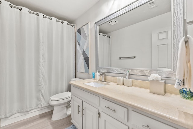 full bath featuring visible vents, toilet, wood finished floors, and vanity