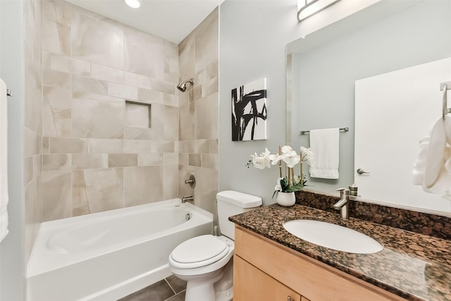 full bathroom featuring tile patterned flooring, vanity, tiled shower / bath combo, and toilet