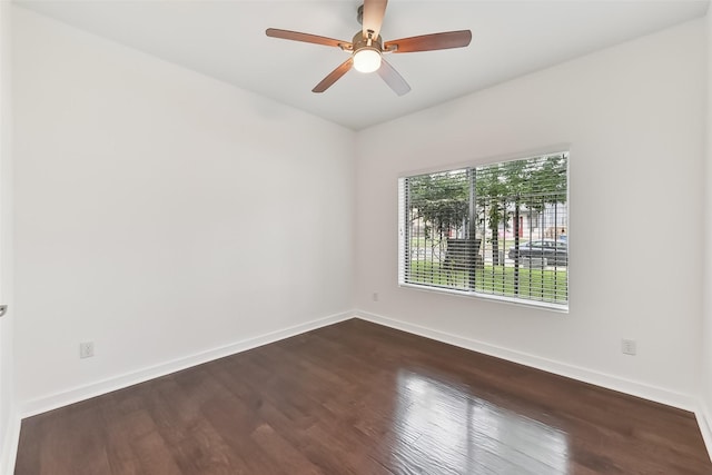 unfurnished room with ceiling fan and dark hardwood / wood-style floors