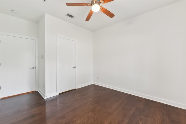 unfurnished room featuring ceiling fan and dark hardwood / wood-style flooring