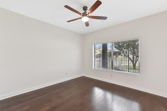 spare room featuring ceiling fan and dark wood-type flooring