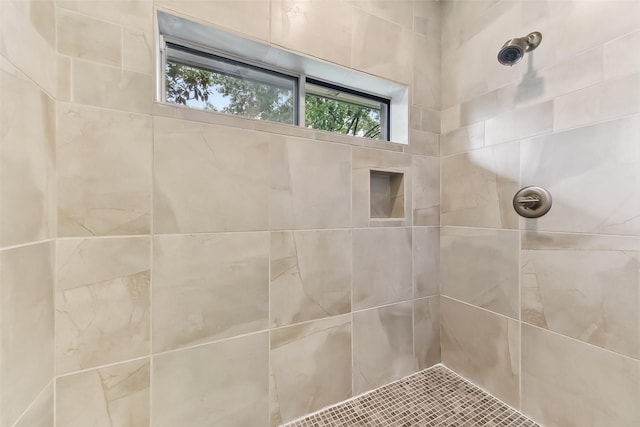 bathroom with tiled shower