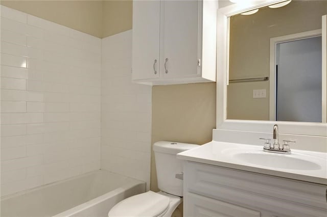 full bathroom featuring washtub / shower combination, vanity, and toilet