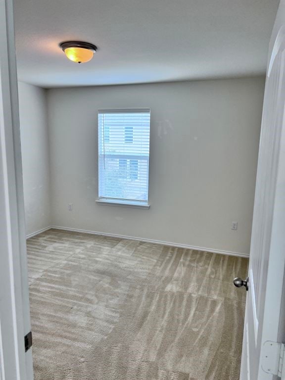 empty room featuring light carpet