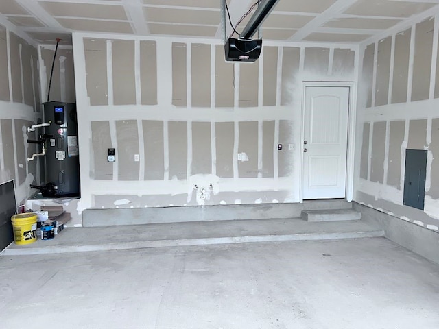 garage featuring heat pump water heater and a garage door opener