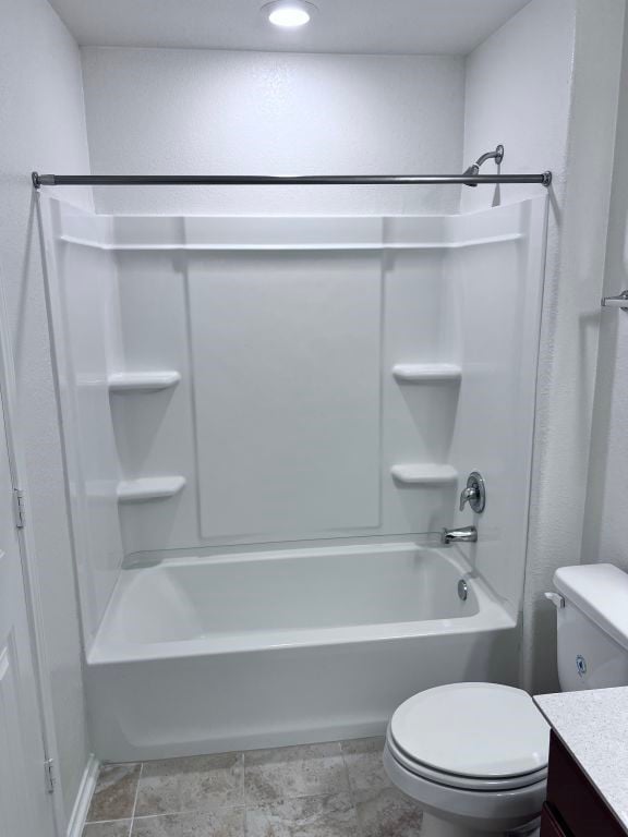 full bathroom with vanity, tub / shower combination, and toilet