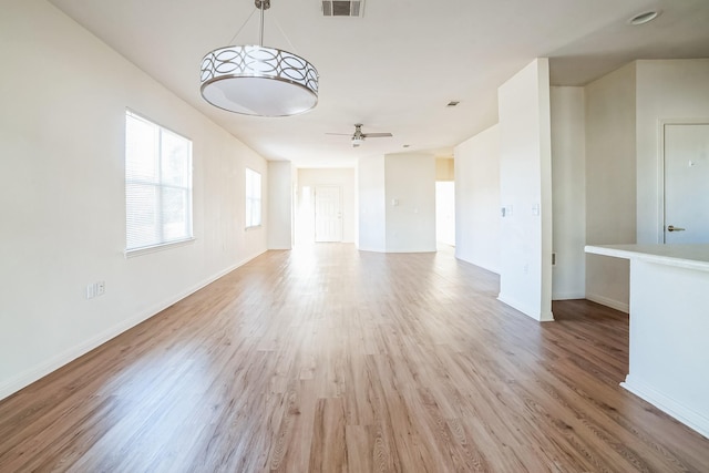 empty room with ceiling fan and light hardwood / wood-style floors