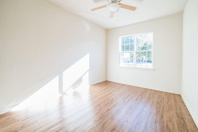 spare room with light wood-type flooring and ceiling fan