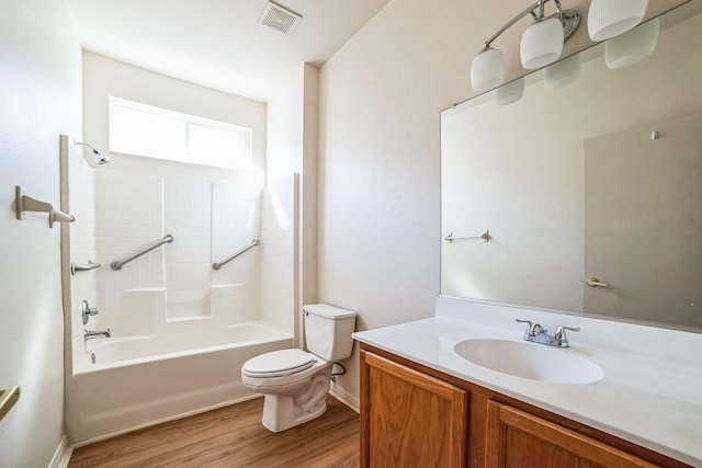 full bathroom with hardwood / wood-style floors, vanity, shower / bathtub combination, and toilet