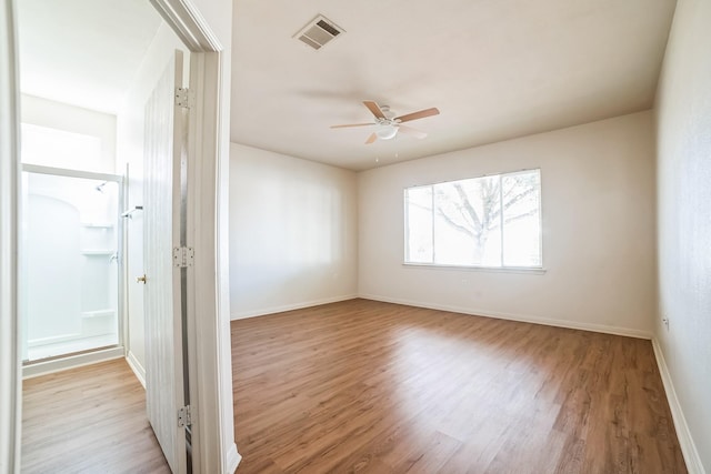 empty room with light hardwood / wood-style flooring and ceiling fan