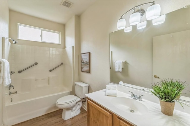 518 Texas Dr, Georgetown, TX 78633 - bathroom featuring wood finished floors, toilet, vanity, and bathtub / shower combination