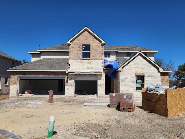 view of front of home featuring a shingled roof and stone siding