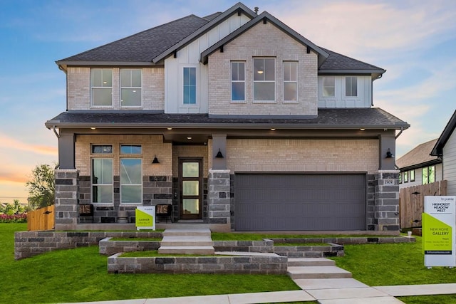 craftsman house with a lawn and a garage