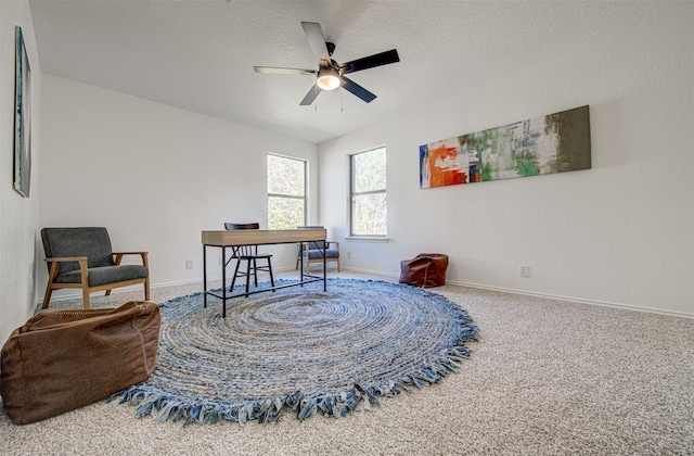 living area featuring ceiling fan and carpet floors