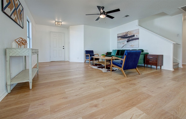 sitting room with light hardwood / wood-style floors and ceiling fan