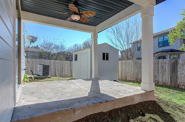 view of patio featuring central AC unit, ceiling fan, and a shed