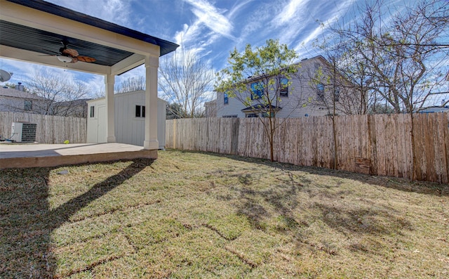 view of yard with ceiling fan and a shed