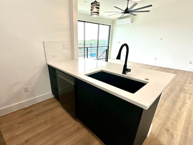 kitchen featuring a wall mounted air conditioner, dishwashing machine, kitchen peninsula, and sink