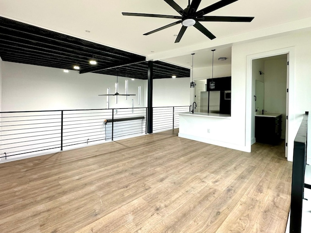 interior space with light hardwood / wood-style floors, ceiling fan, and sink